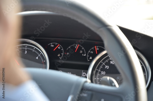 Closeup image of car dashboard through steering wheel during the day © branislav