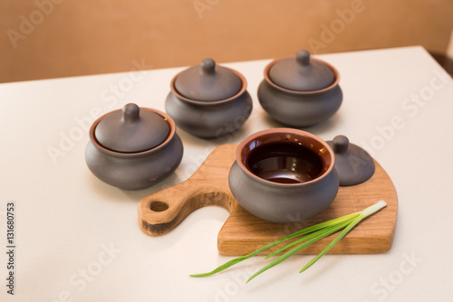 clay pots on the table, onions 