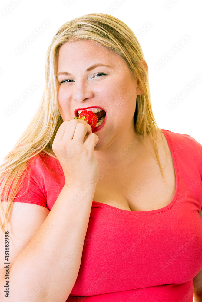 Happy young blond woman eating healthy strawberry. Happy young blond woman eating healthy strawberry.