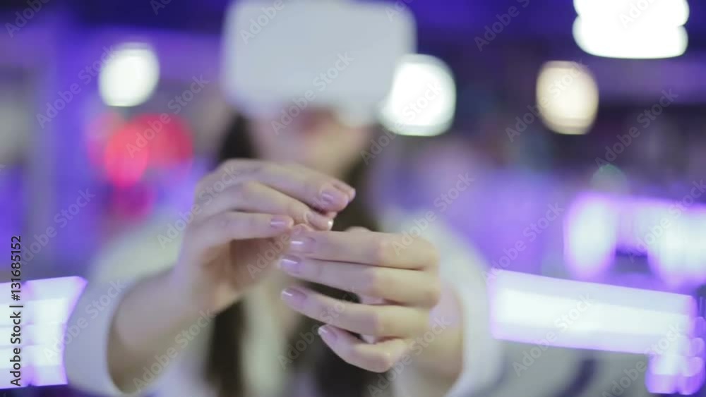 Young beautiful woman is trying a new gadget. Young beautiful woman is trying a new gadget.