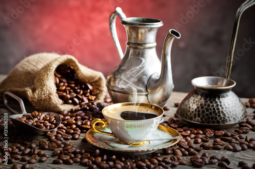 Black coffee in a cup on old background