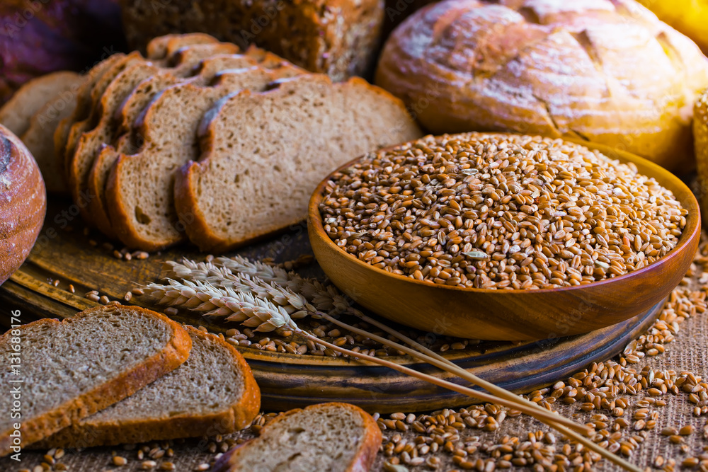 Bread with wheat grains on the old background