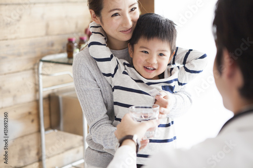 Mother and son are consulting with a clinic photo