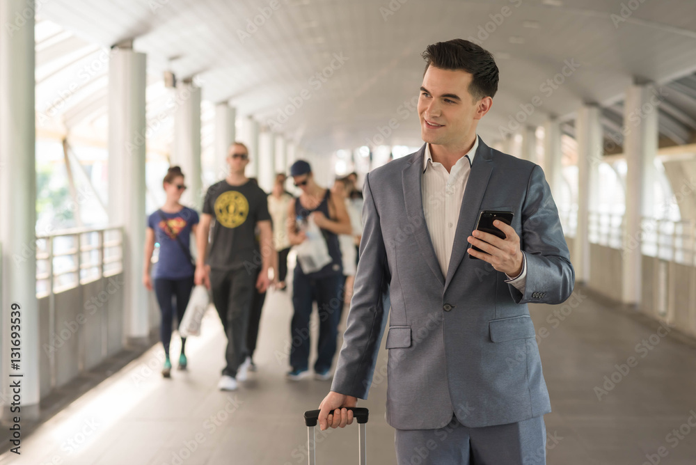 Westerner Business man talking via smart phone on the walk way w Westerner Business man talking via smart phone on the walk way w