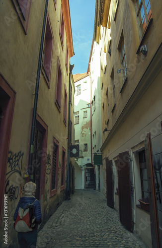 Girl at narrow medieval street in Prague.