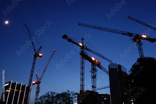 Cranes  silhouettes  at night, construction site