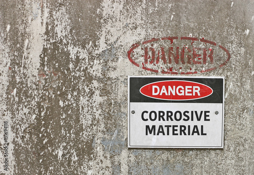 red, black and white Danger, Corrosive Material warning sign