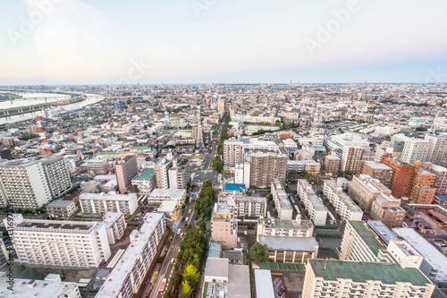Business and culture concept - panoramic modern city skyline bird eye aerial view under dramatic sunset glow and beautiful cloudy sky in Tokyo, Japan © voyata