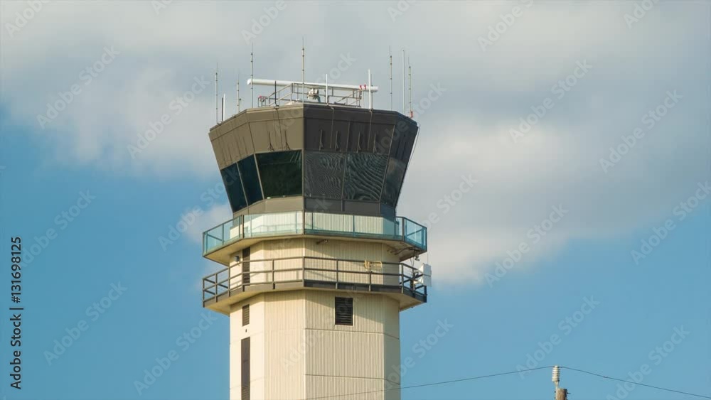 Closeup of the ATC Air Traffic Control Tower of Houston TX Hobby Airport HOU on a Sunny Afternoon with Radar Spinning between Radio Antennas during Good Texas Weather Closeup of the ATC Air Traffic Control Tower of Houston TX Hobby Airport HOU on a Sunny Afternoon with Radar Spinning between Radio Antennas during Good Texas Weather
