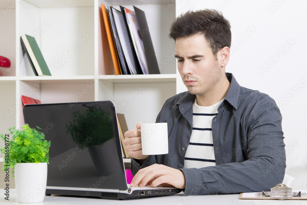 man drinking coffee and surfing the internet with the laptop computer man drinking coffee and surfing the internet with the laptop computer