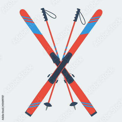 Pair of red skis and ski poles photo
