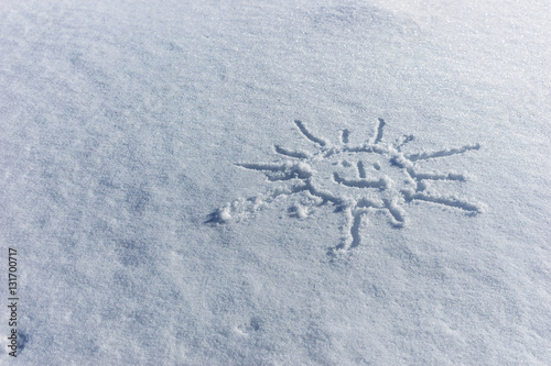 Sun drawn in the fresh white snow