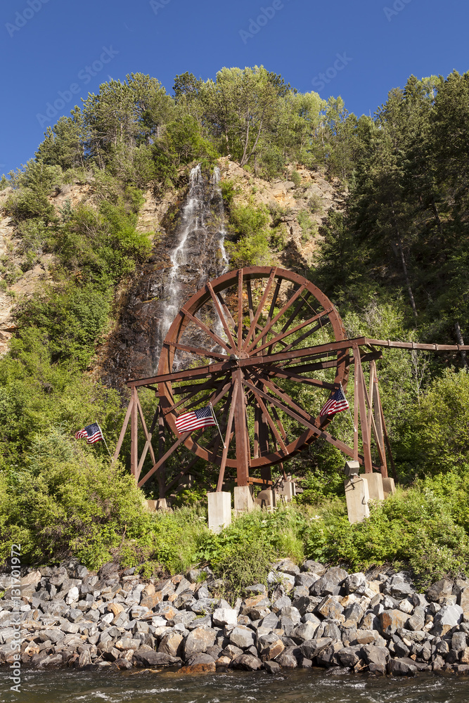 Waterfall and water wheel in Idaho Springs Colorado next to the I-70 Freeway.