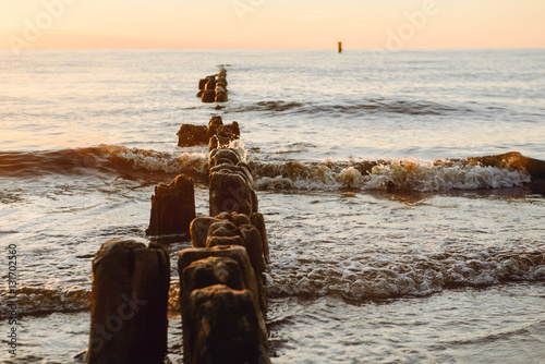 Fototapeta Naklejka Na Ścianę i Meble -  Breakwaters in the Baltic sea over the sunset