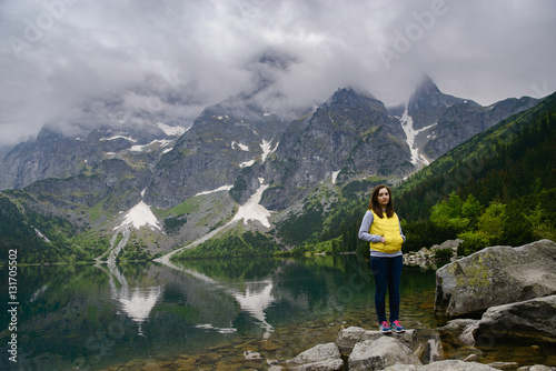 woman relaxing on the lake and mountains sunny landscape