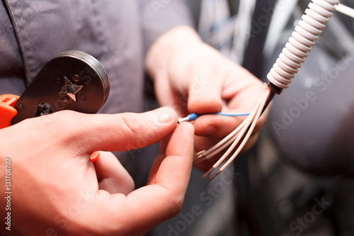 Hands of young electrician.