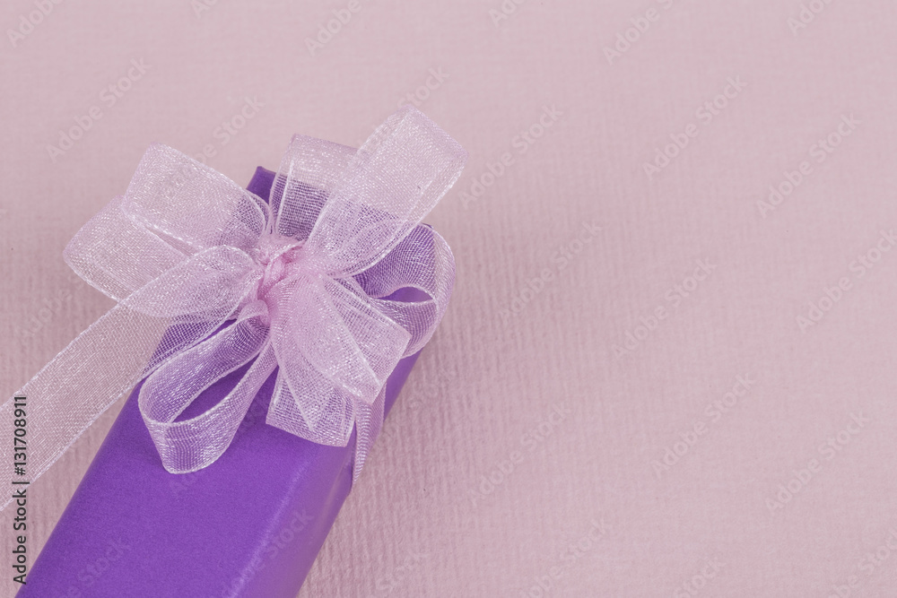purple gift box with pink bow