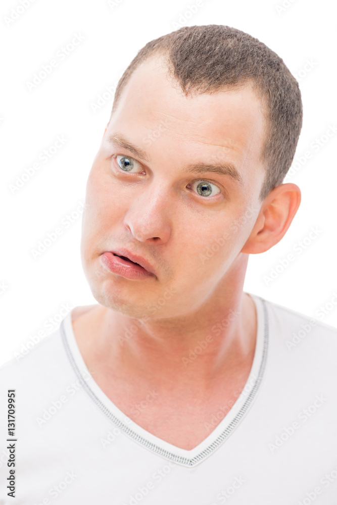 Fototapeta premium cheerful face with a grimace young man isolated