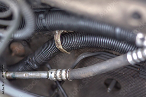 Close up view of an installed car engine,  air conditioner hose