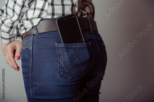 smartphone in the pocket of jeans