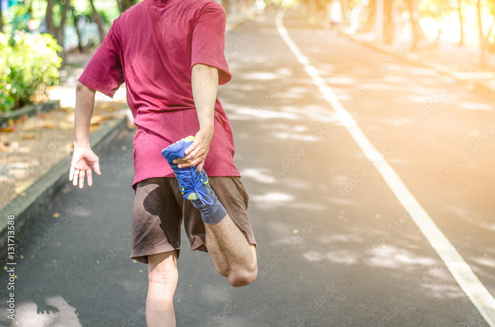 Obraz premium Man warming up before running , Fitness and lifestyle concept.