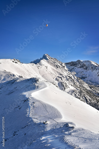 Balloon over the snowy Swinica peak. Tatra mountain