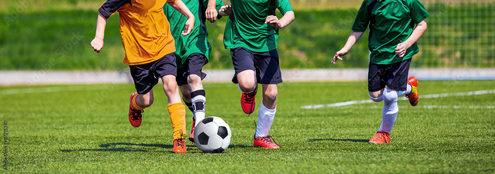 Running Youth Football Players. Kids Playing Football Soccer Game on Sports Field. Boys Play Soccer Match on Green Grass. Youth Soccer Tournament Teams Competition. Running Youth Football Players. Kids Playing Football Soccer Game on Sports Field. Boys Play Soccer Match on Green Grass. Youth Soccer Tournament Teams Competition.