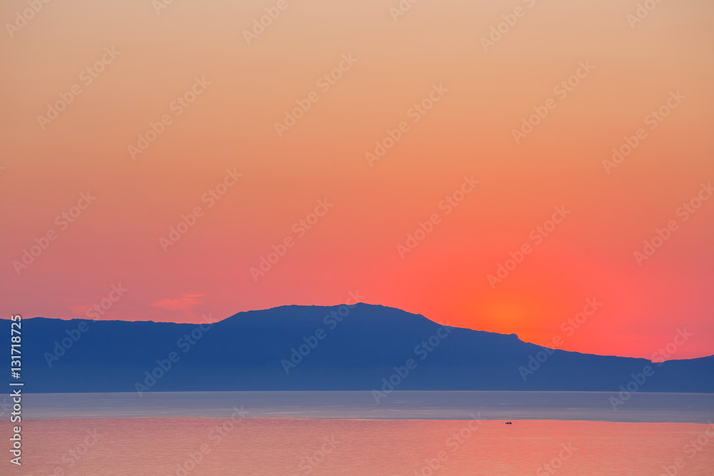 sunset over the mountain with reflection on the sea sunset over the mountain with reflection on the sea