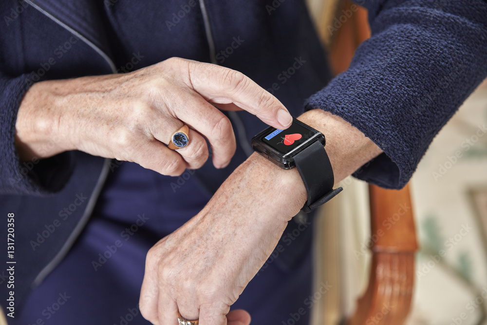 Senior woman checking medical data on smartwatch Senior woman checking medical data on smartwatch