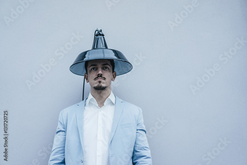 Man wearing lampshade as hat photo