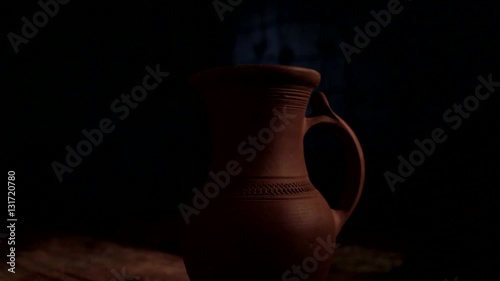 The jug is highlighted in a searchlight photo