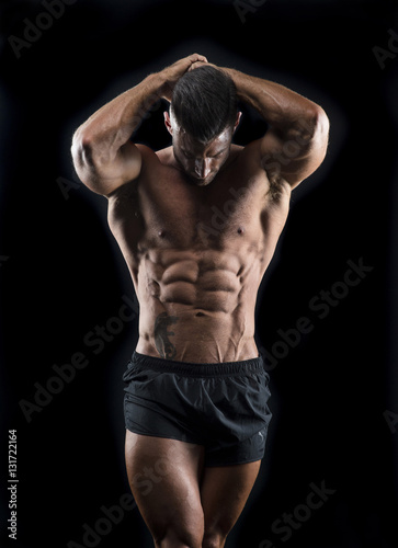 Muscular man showing abs 