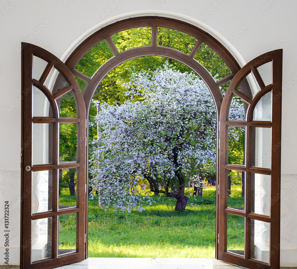Fototapeta premium open door arch garden bloom in spring