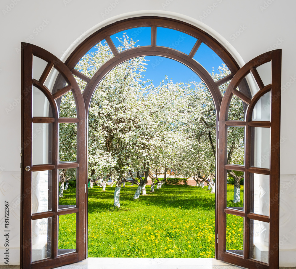 Fototapeta premium open door arch garden bloom in spring