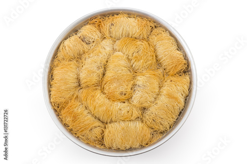 Turkish pastry cake kadaif pieces, traditional sweet, arranged in a baking pan isolated on white background photo