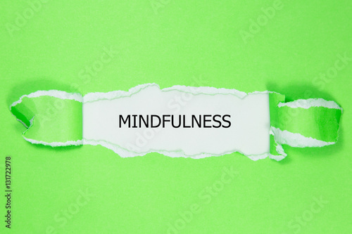 Mindfulness word written under torn paper photo