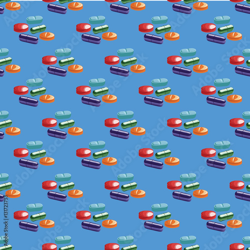 Seamless pattern with colored pills on blue background