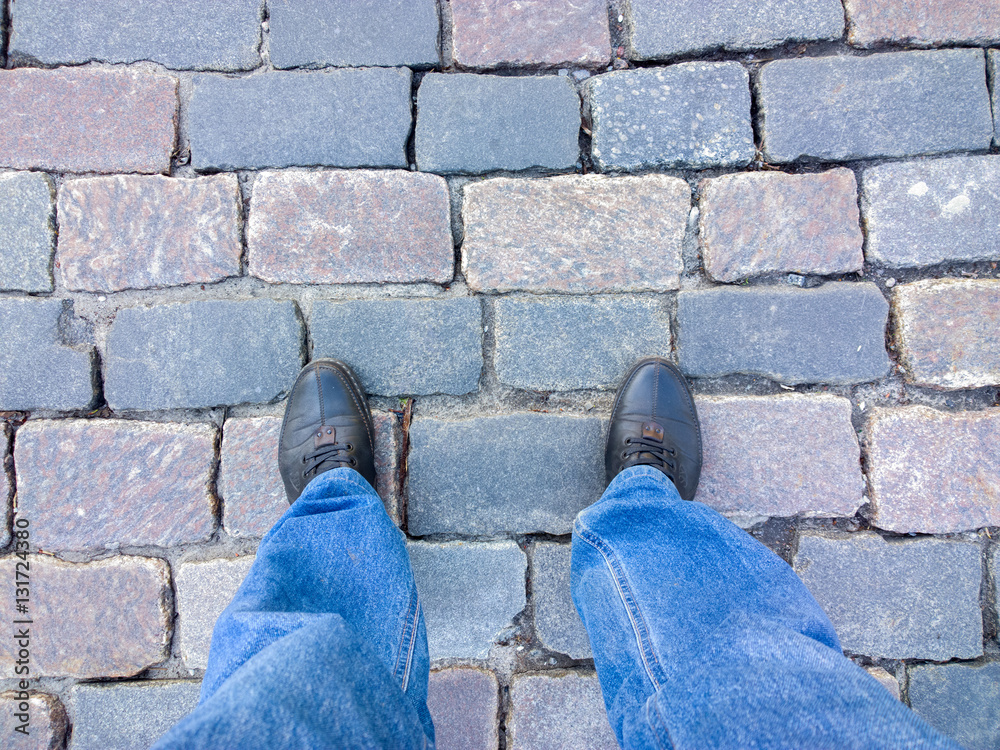 Feet on the cobblestone.