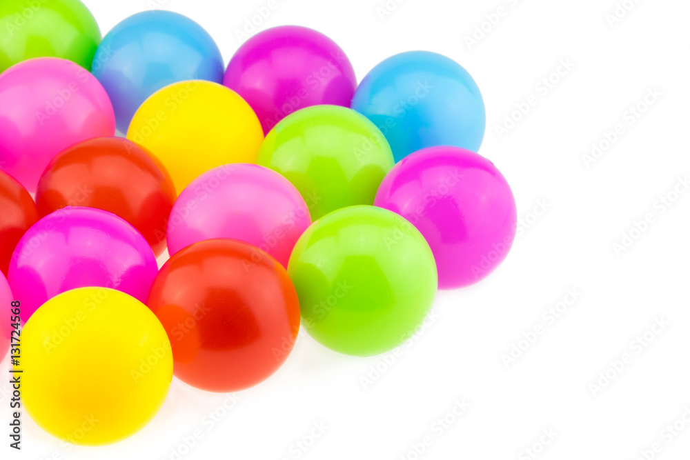 Many colour plastic balls on white background.