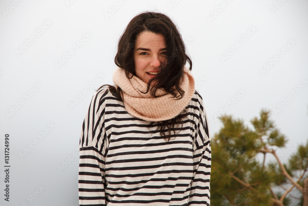 Portrait of a pretty caucasian girl on the mountain in a snowy day with foggy background. She is on a travel trip and enjoys the scenery and freedom. Portrait of a pretty caucasian girl on the mountain in a snowy day with foggy background. She is on a travel trip and enjoys the scenery and freedom.