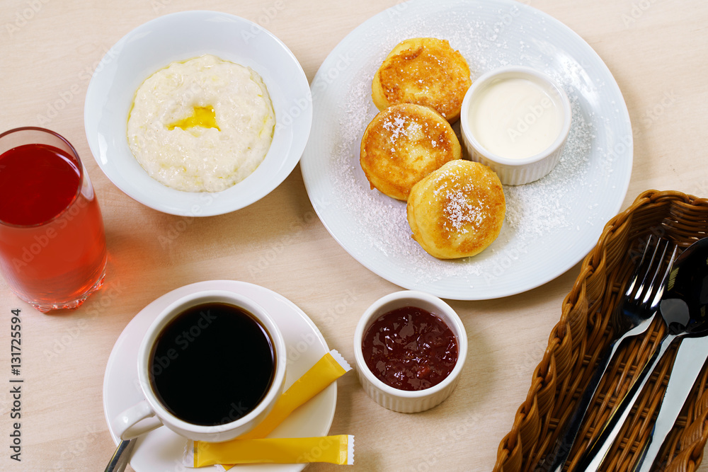 Set table with porridge cheesecakes coffee in cafe Set table with porridge cheesecakes coffee in cafe