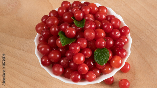 Cherry in a bowl on the table.