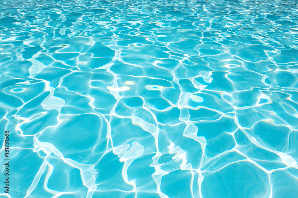 Beautiful blue water surface in swimming pool with sun reflectio