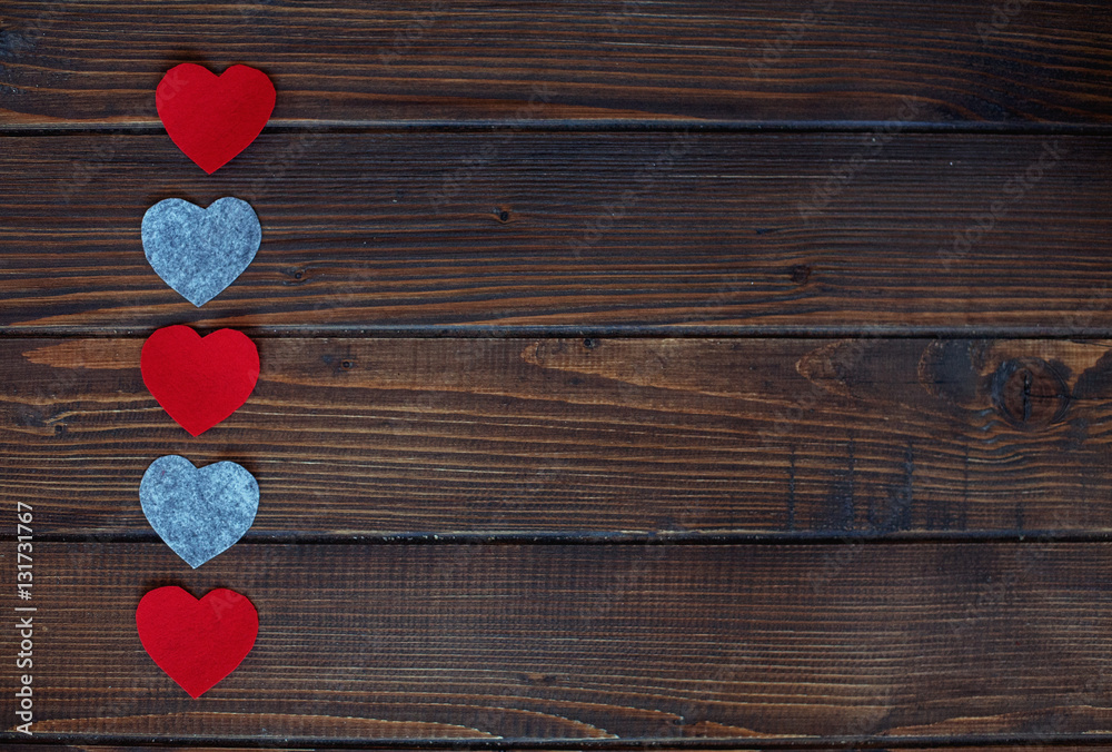 Fototapeta premium Hearts on a wooden background. The concept of Valentine's Day