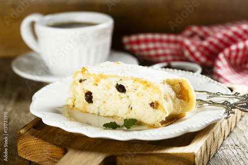 Homemade strudel with cottage cheese, apples and raisins photo