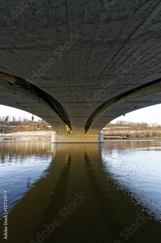 Reflection of a bridge in the clear river water that it is passing over