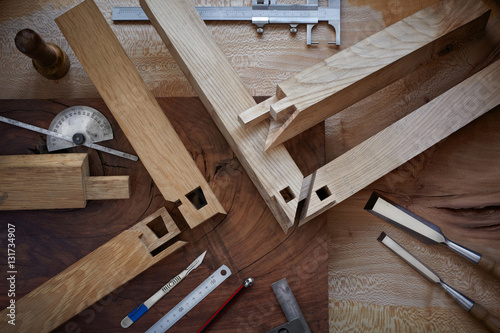 Overhead shot of intricate Japanese joinery and hand tools photo