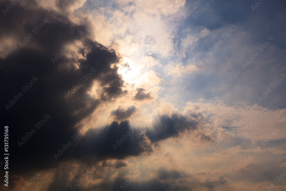 Sun behind clouds background
