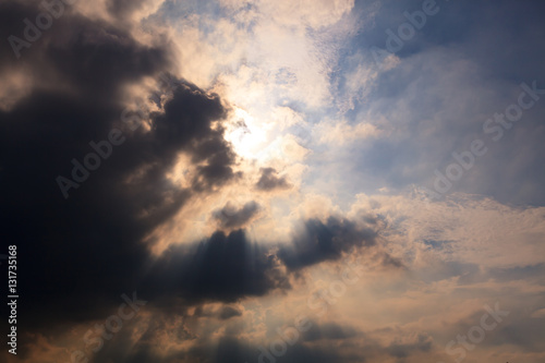 Sun behind clouds background