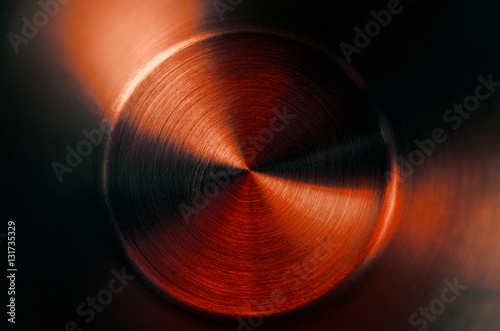 Abstract steel circle in dark  background or metallic grey green brown orange yellow lime pink disc  surface,with crossing circles and ovals.  illustration can be used as wallpaper or button design